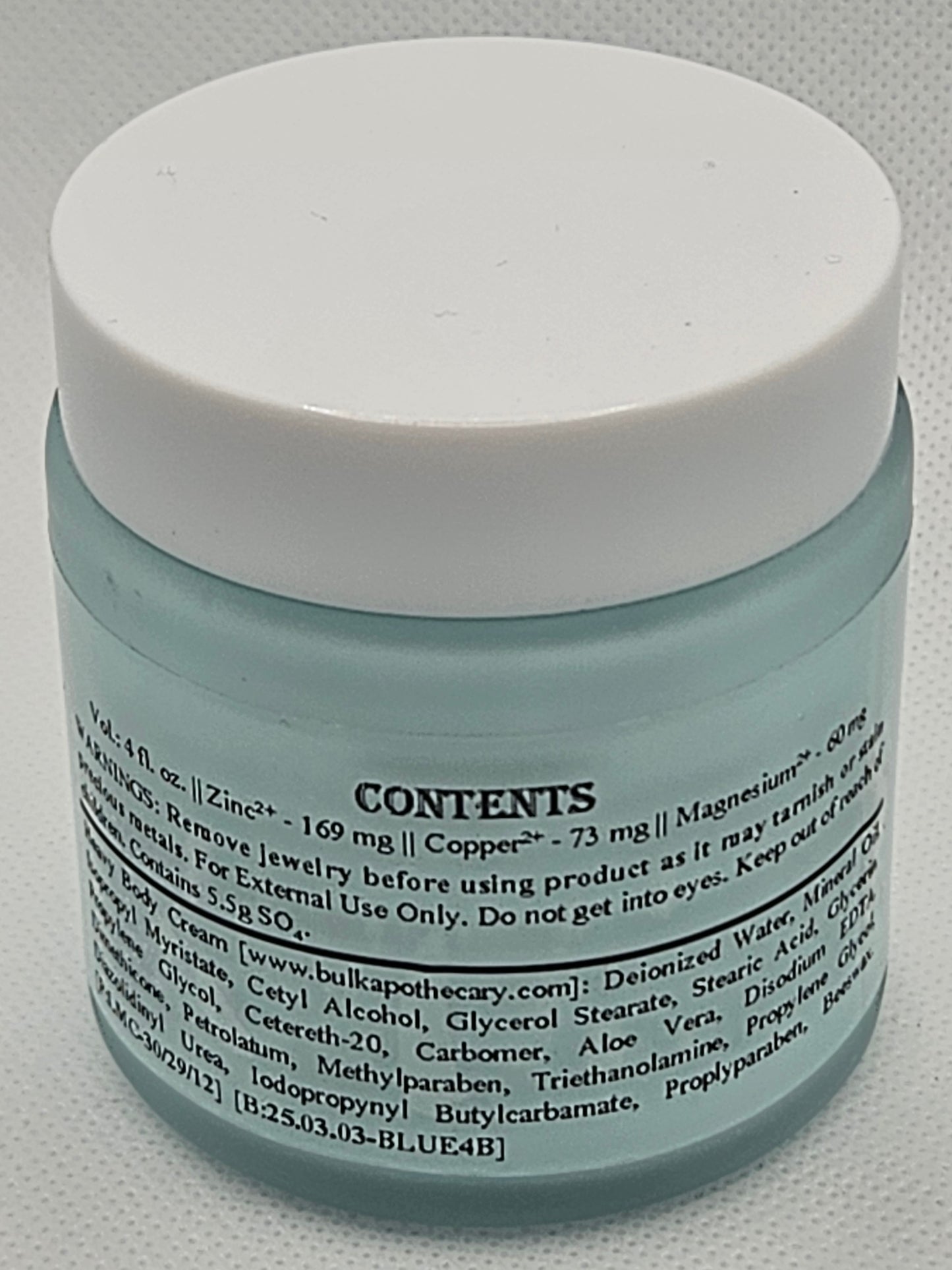 The Blu Cream - Zinc, Copper, and Magnesium comes in a light blue translucent jar with a white lid. Its label lists zinc, copper, magnesium, deionized water, and usage instructions to help soothe damaged skin.